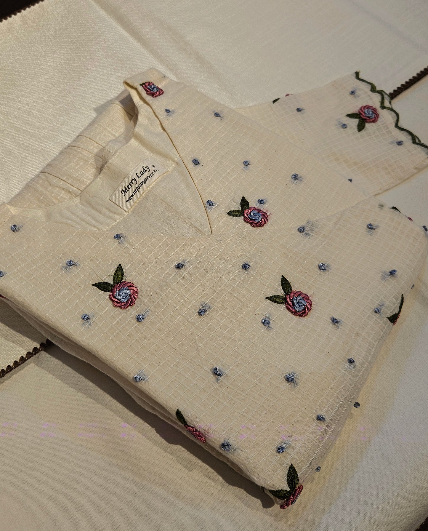 Off white soft cotton kota checks kurti/dress with overlapped yoke enriched with hand embroidery detailings MBS-708